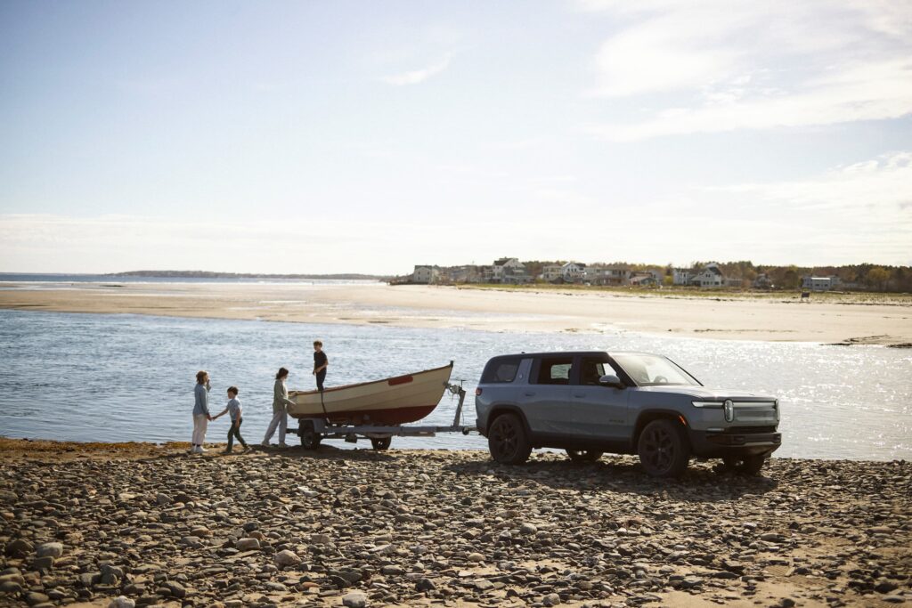 Family on the beach with a Rivian R1 S