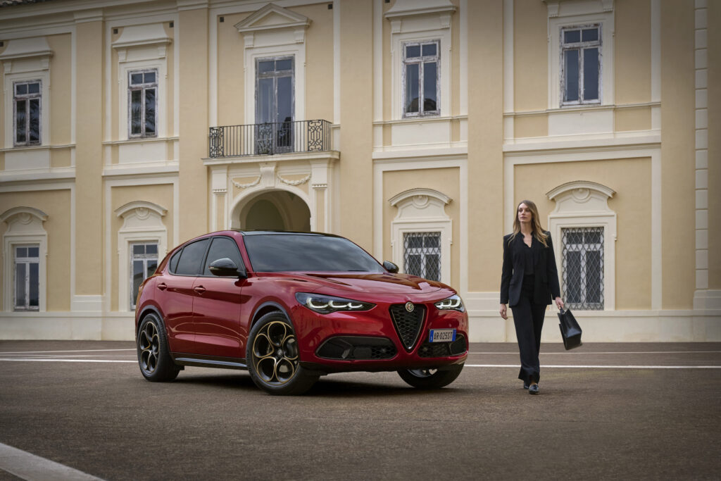 Woman in front of Italian building walking towards the Alfa Romeo Stevia