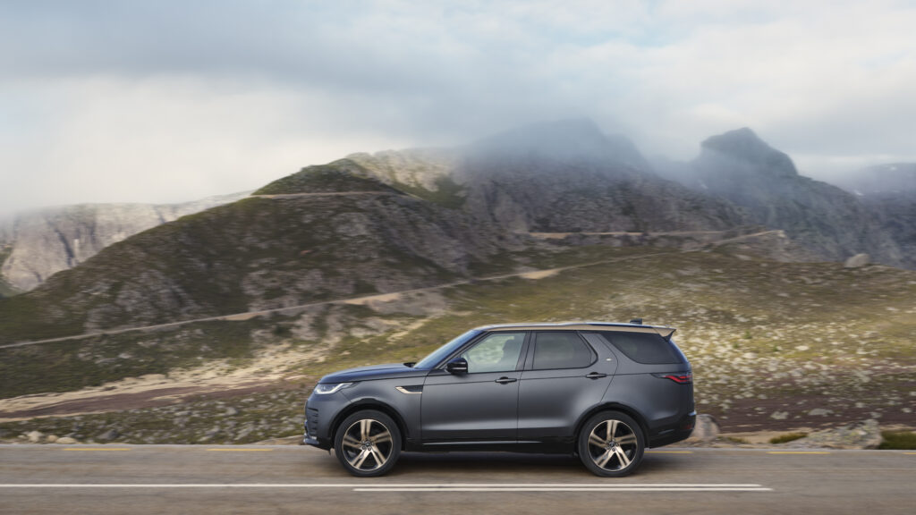 Side view of a Land Rover discovery Tempest in Gray on a mountain Road