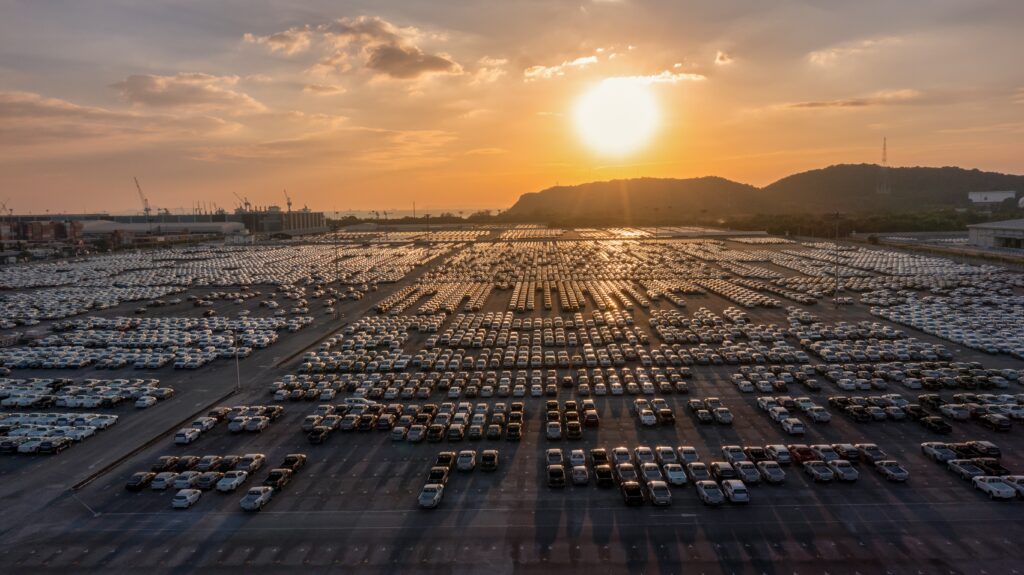 Thousands of cars sit, waiting to go to dealerships to be sold