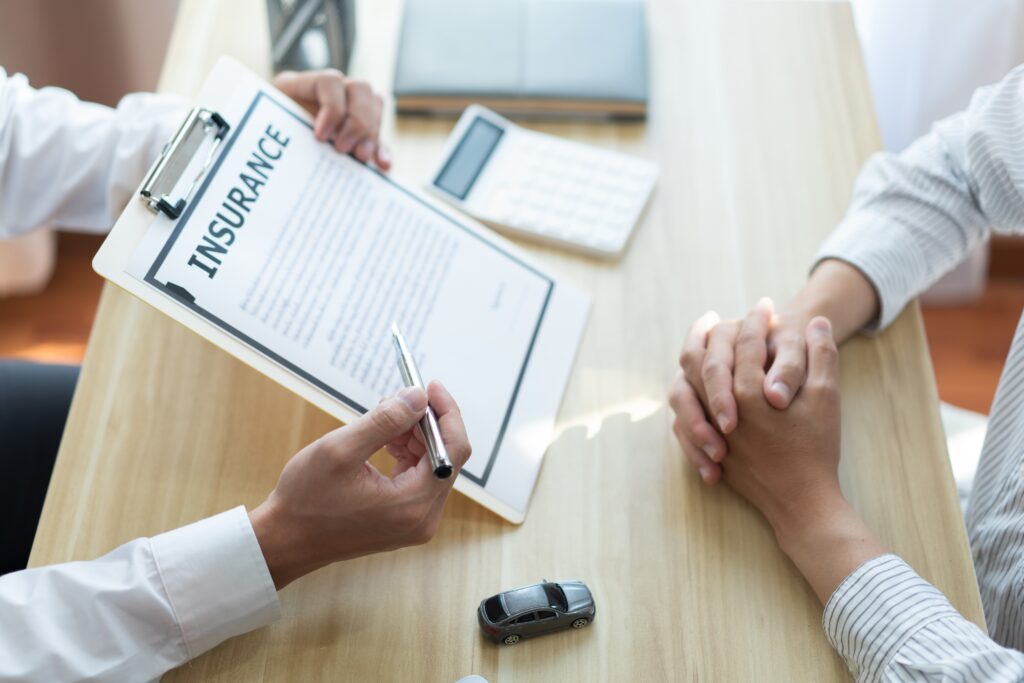 Agent having a customer fill out a car insurance form