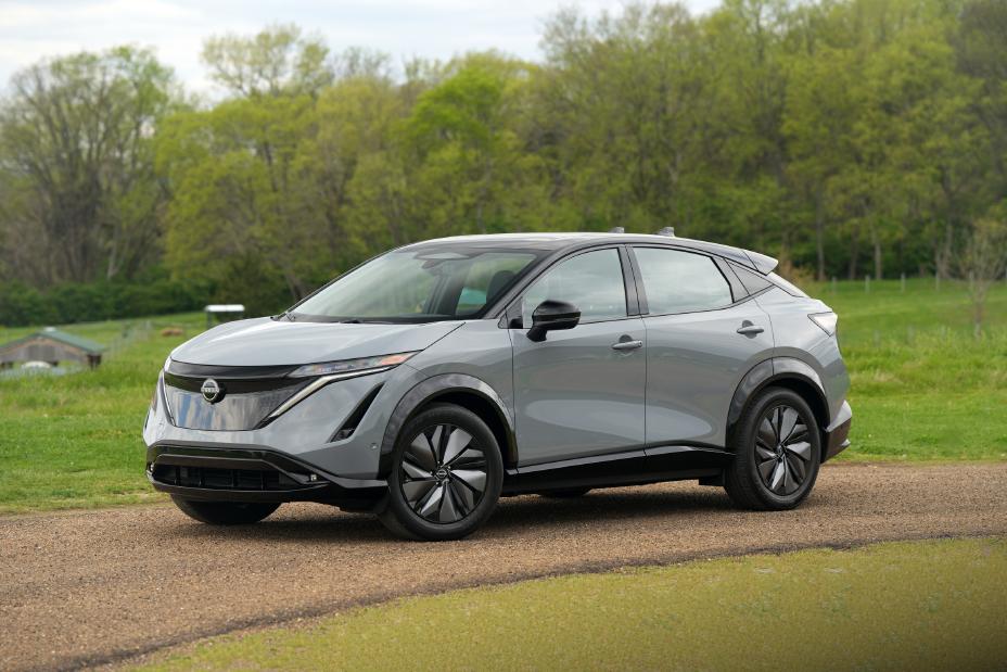 2025 Nissan Ariya, sitting on a dirt road amongst the trees
