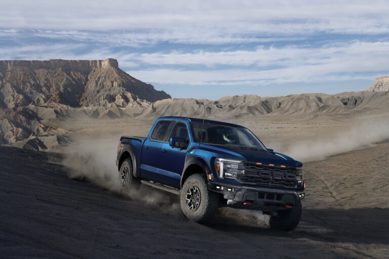 2025 Ford F-150 Raptor R driving through a desert landscape
