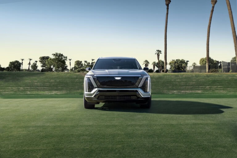 The 2026 Cadillac VISTIQ front fascia featuring the Cadillac vertical light signature, sleek LED headlamps and the black crystal shield grille design. Shown here in Argent Silver.