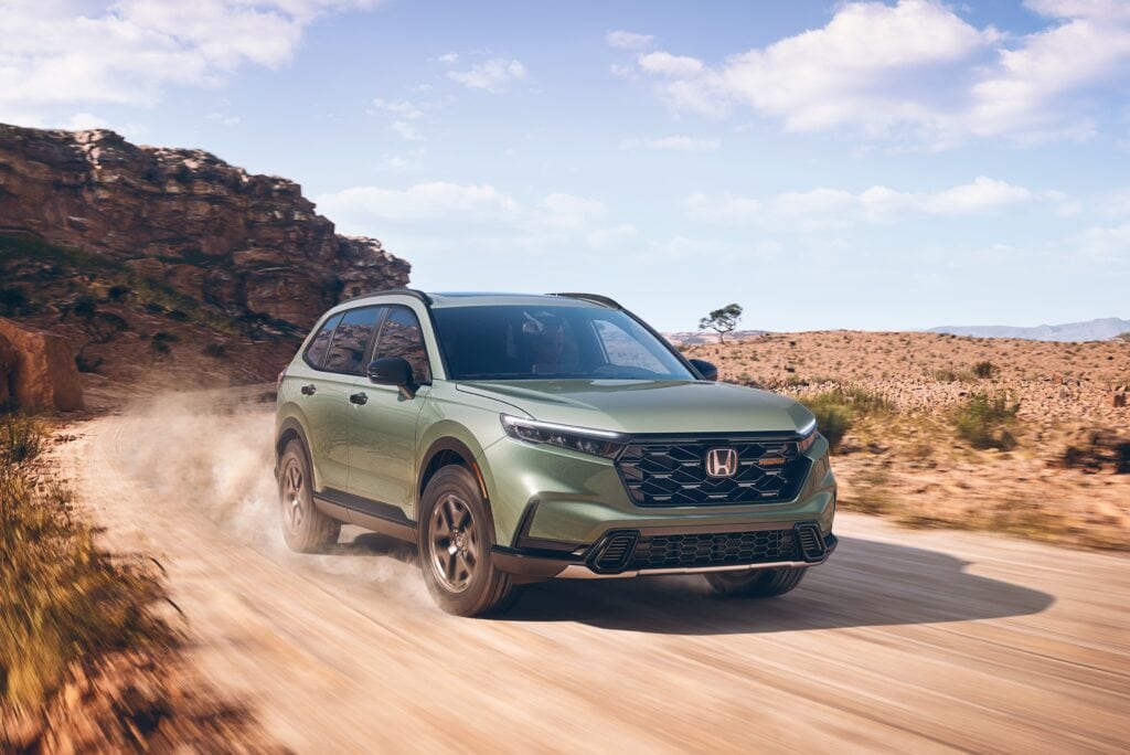 2026 Honda CR-V TrailSport Hybrid driving on a dirt road.