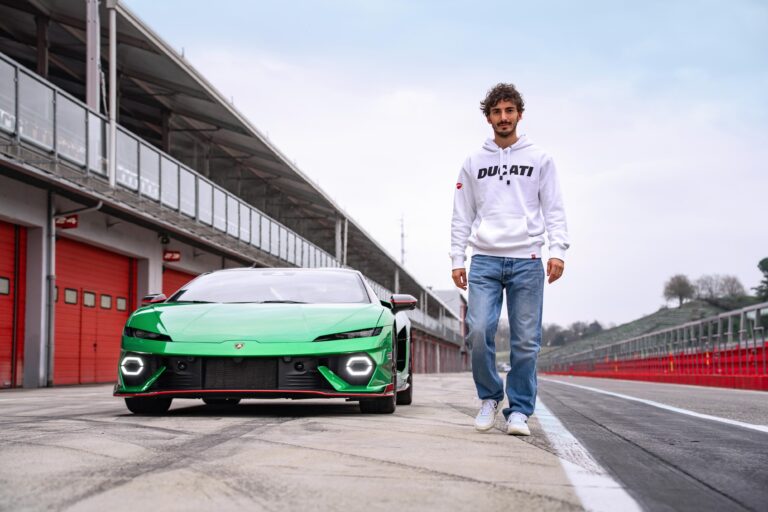 Francesco ‘Pecco’ Bagnaia walking past the Lamborghini on the track
