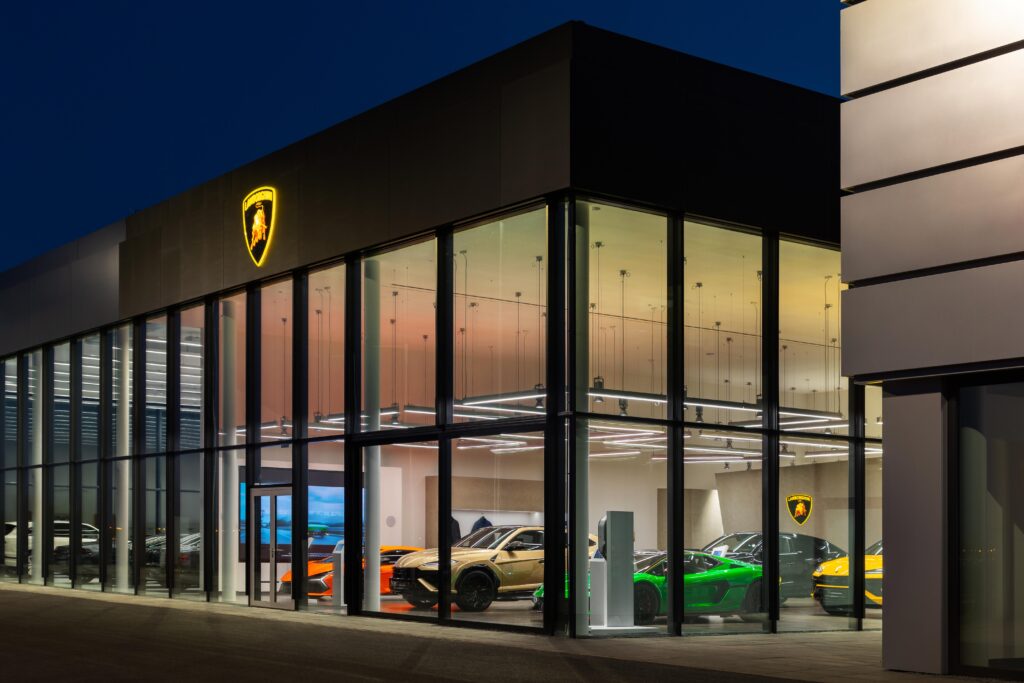 The Lamborghini Prague showroom at night filled with colorful cars
