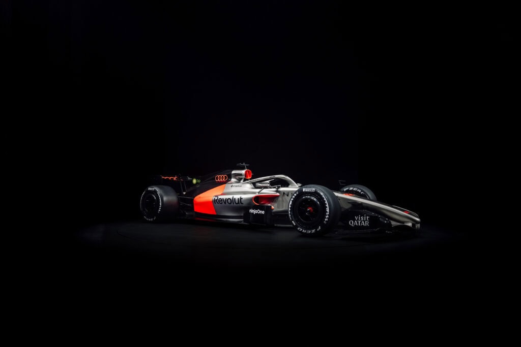 The Audi Revolut F1 Team R26 Livery shown at a front three quarter angle highlighting the car's colors and graphics