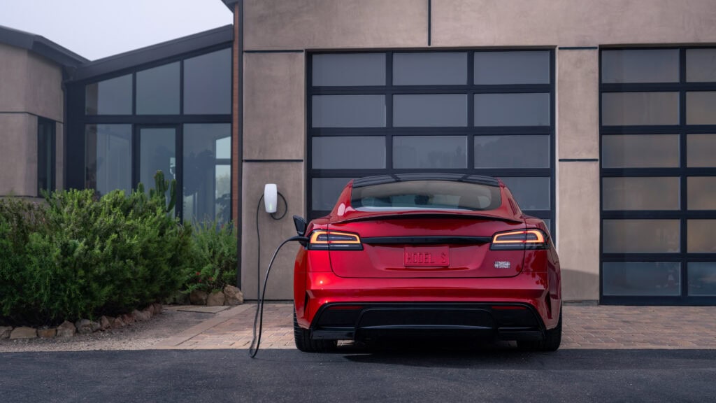 Fastest Cars Under $50k_Tesla Model S Plaid charging in front of a house