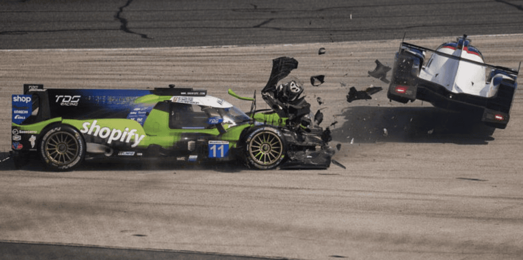 The No. 11 TDS Racing LMP2 of Tobi Lutke, Mathias Beche, David Heinemeier Hansson and Charles Milesi crashes into another LMP2 competitor on the first lap of the Rolex 24 at Daytona.