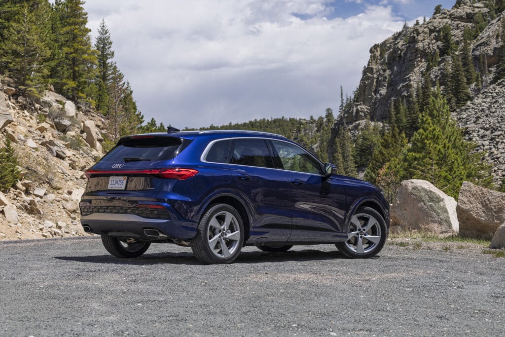 2026 Audi Q5 parked in the mountains around pine trees and rocks
