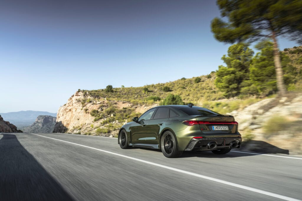 2027 Audi RS 5 Sedan driving on a mountain road