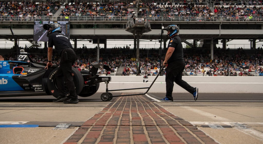 An Indy car being pushed across the bricks during Final Practice