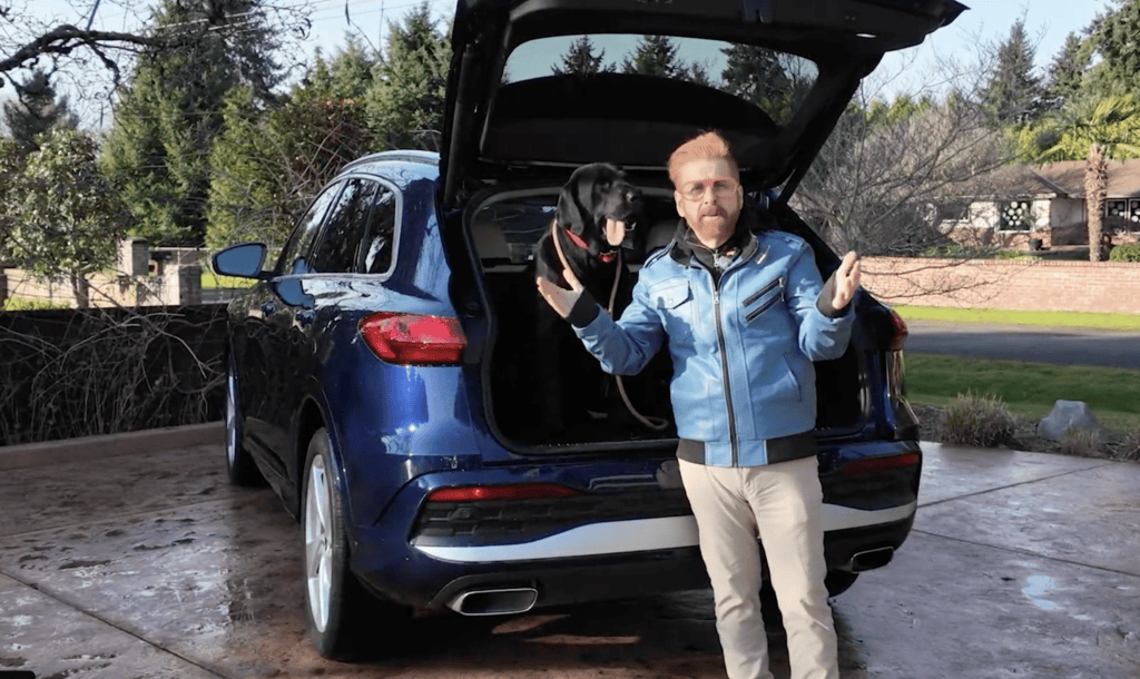 2026 Audi Q5 with Bill the Dog looking at the trunk area