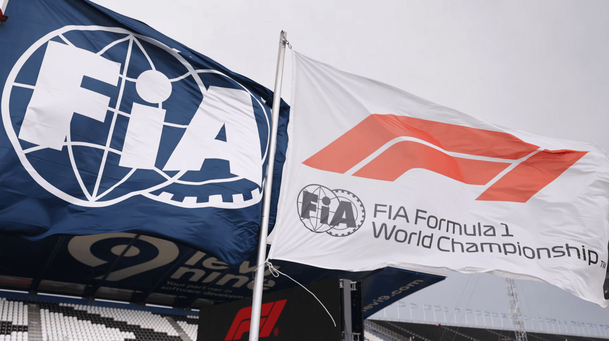 FIA and F1 flag flying next to each other signifying the partnership between the two organizations.