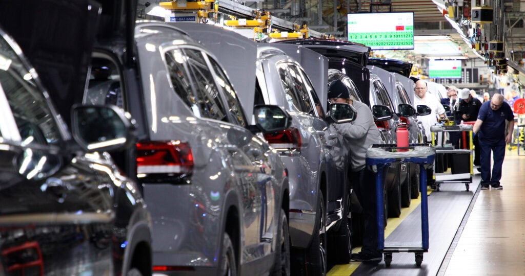 Volkswagen factory with a line of cars moving down the assembly line