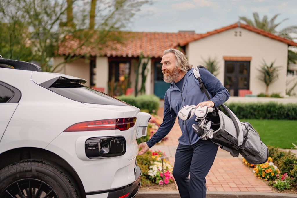 Waymo picking up a person for a day of golfing