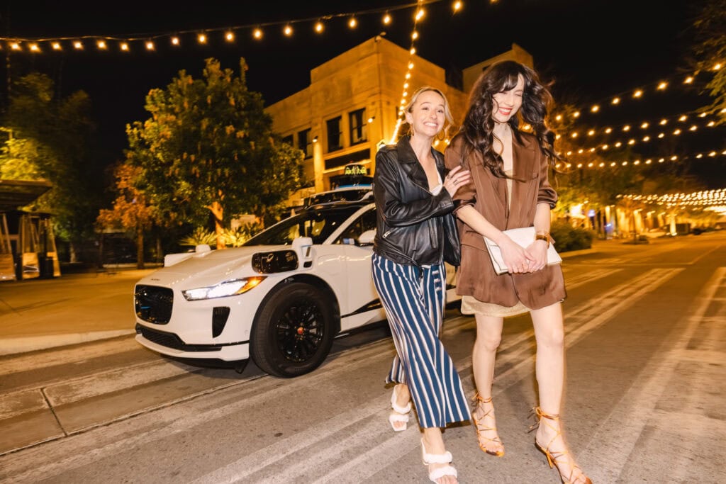 Waymo dropping off two woman for a night out.