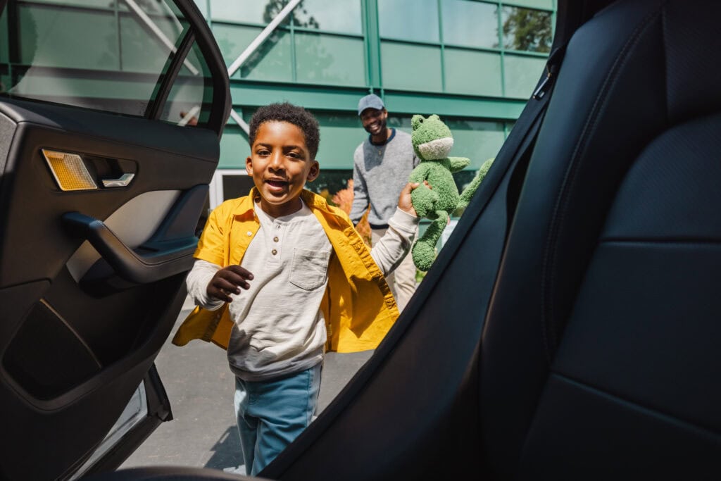Waymo vehicle picking up two people.