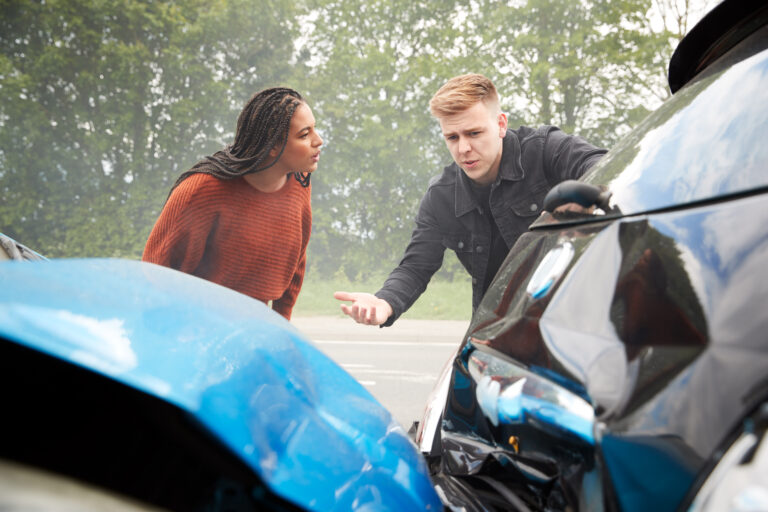 Kupl looking at car that has been in an accident